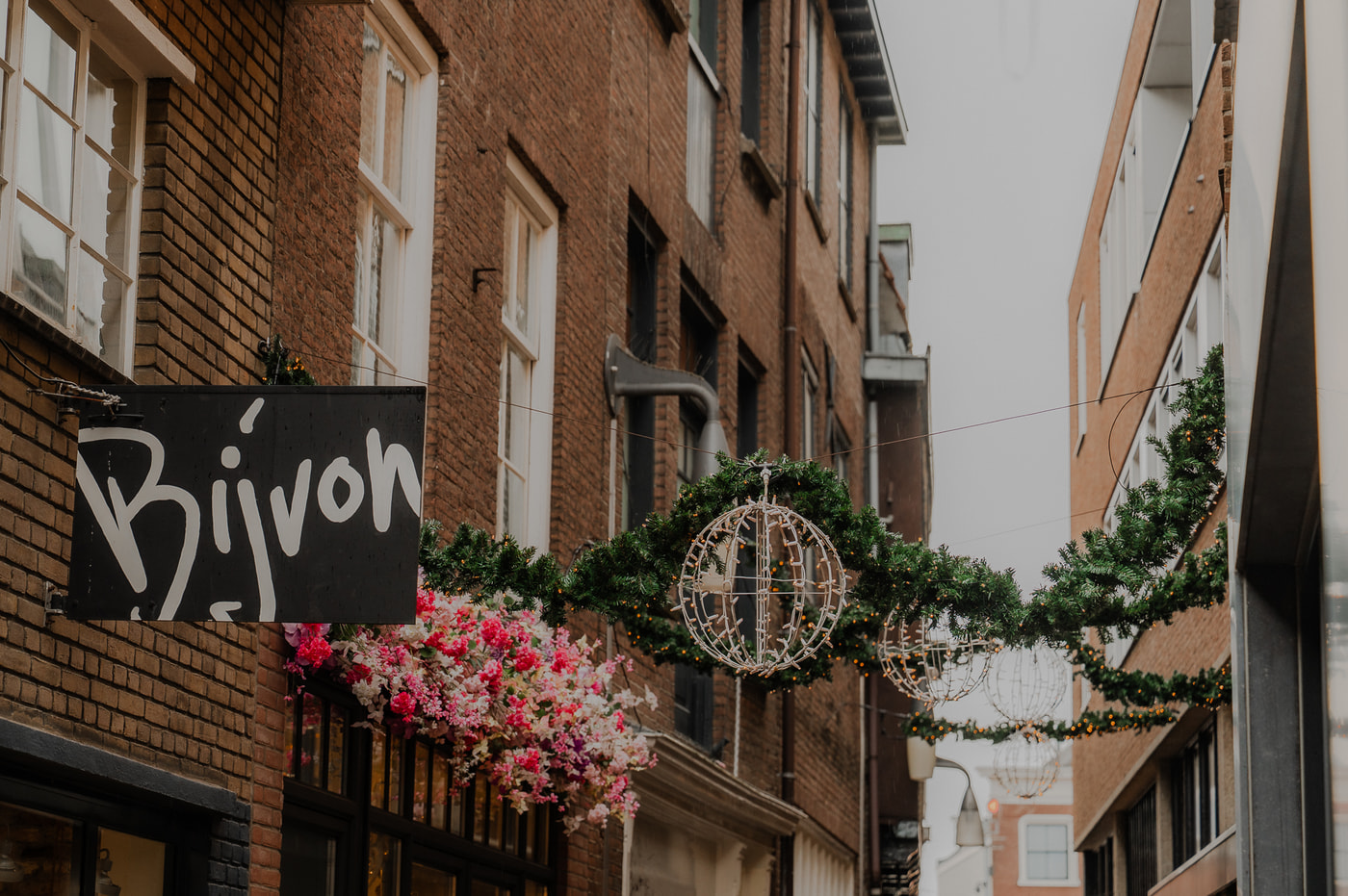 Winkelstraat met kerstverlichting en kledingwinkel Bijvon